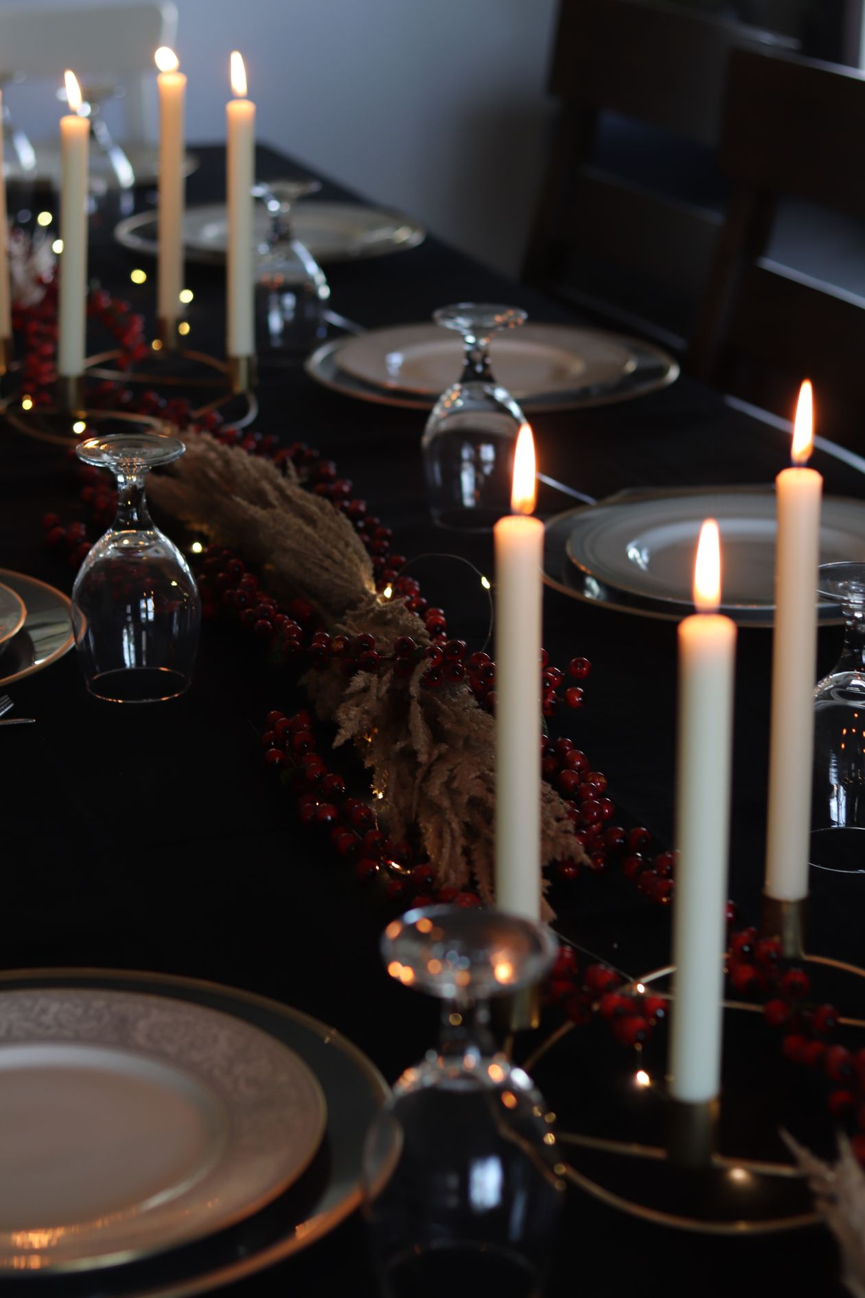 Elegant banquet table with lit candles set for an anniversary celebration