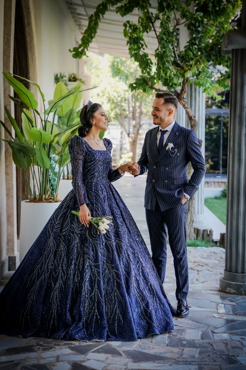 Elegant bride and groom in formal wedding attire sharing a joyful moment outdoors