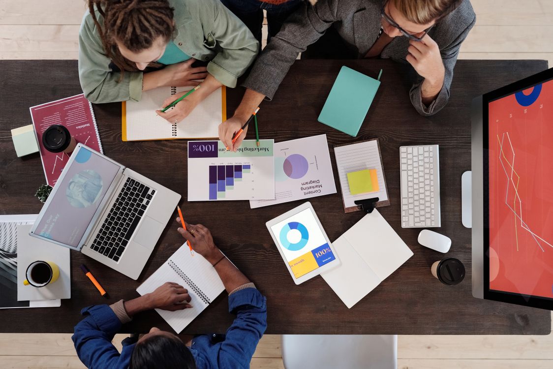 Overhead view of a team working together on a project in a contemporary workspace