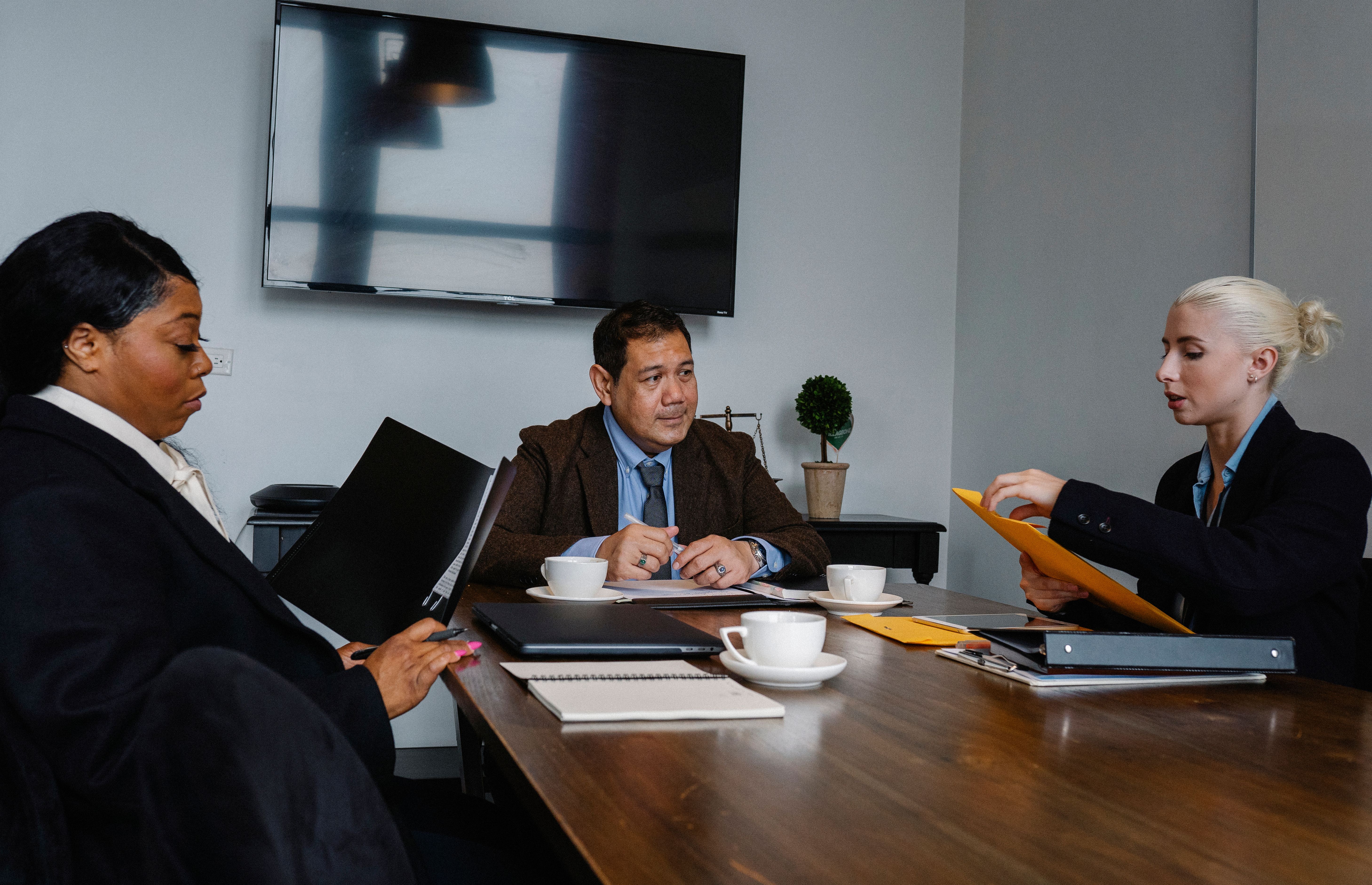 Colleagues reviewing strategy documents during a focused office meeting