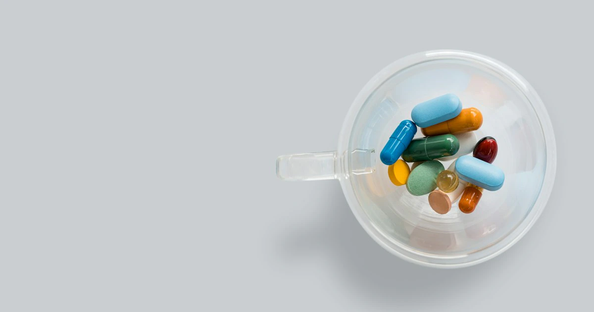 Supplement capsules spilling from a bottle onto a surface