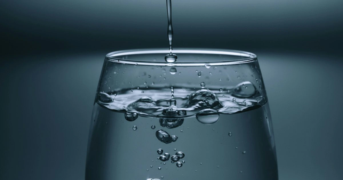 Clear glass of water on a neutral background