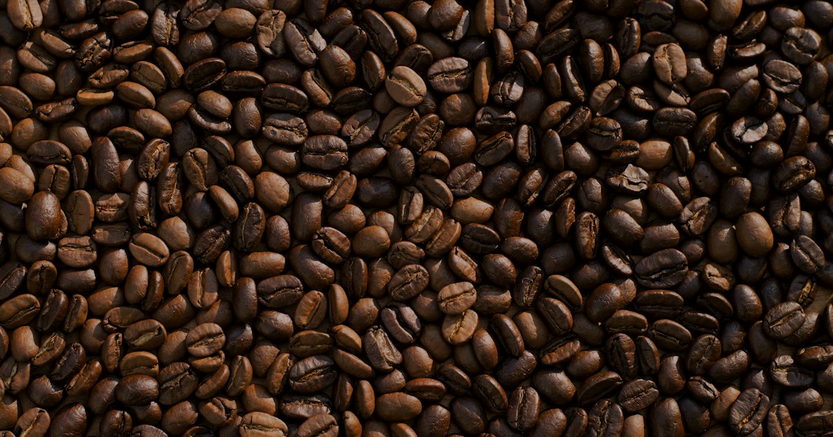 Fresh roasted coffee beans in warm light showing rich brown color and texture