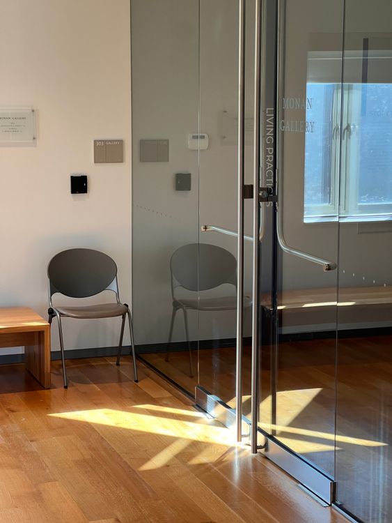 Puerta de vidrio en interior de oficina con piso de madera