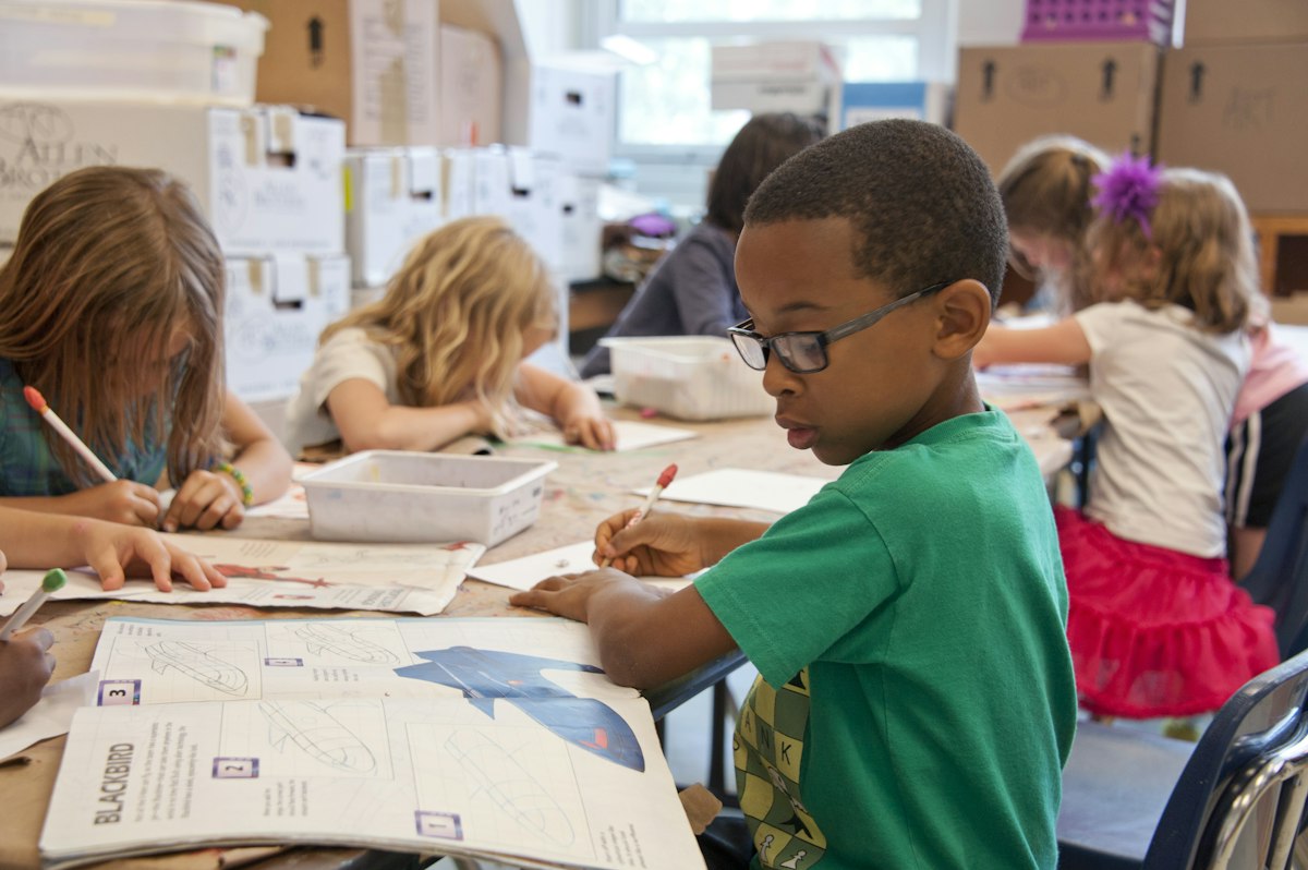 Close-up of sturdy school desks with chairs in a classroom