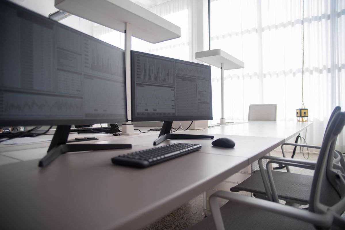 Modern dual-monitor workstation setup with an ergonomic keyboard arrangement