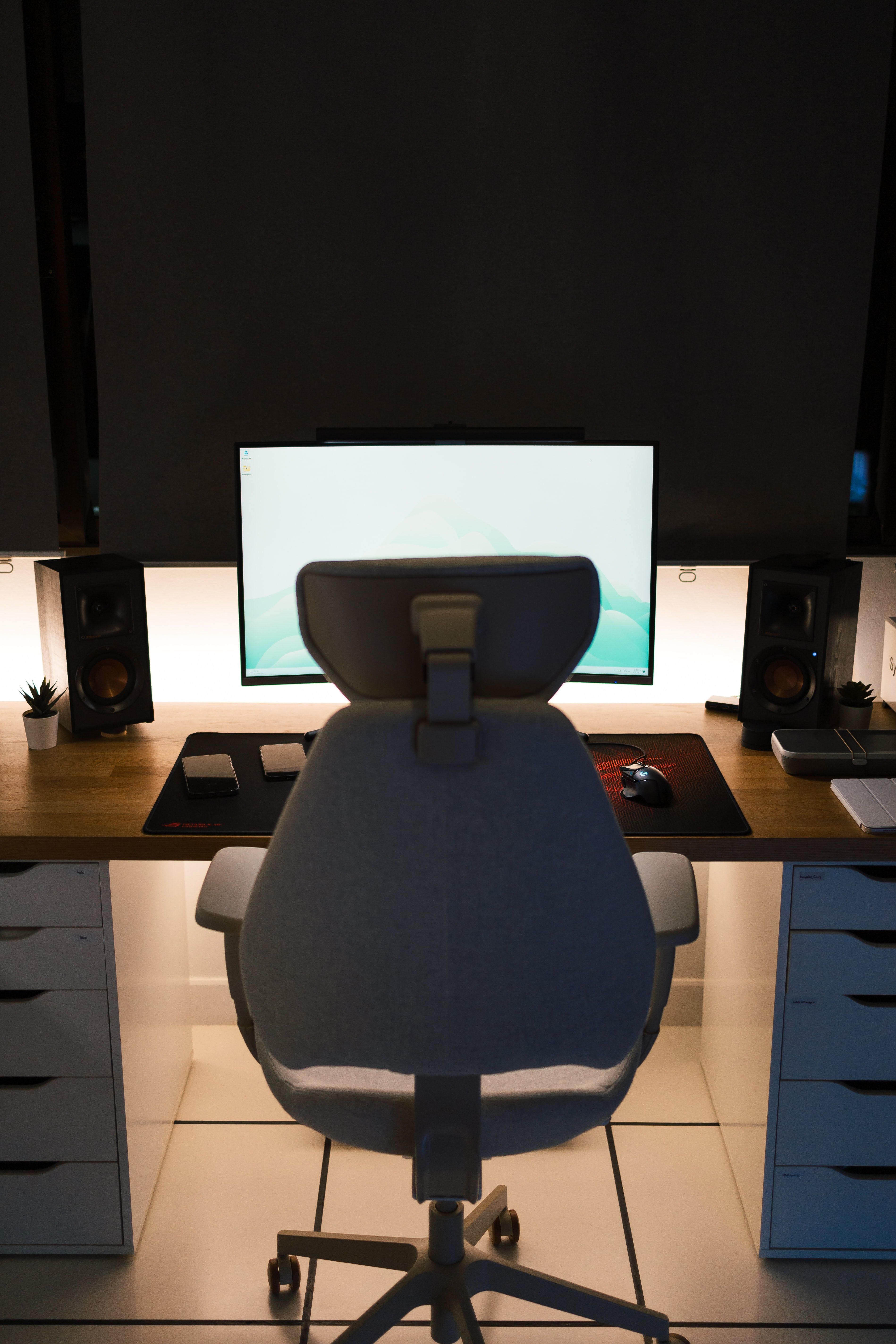 Side view of a modern home office desk with an ergonomic chair