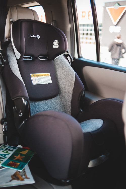 Child safety car seat installed in the back of a vehicle interior