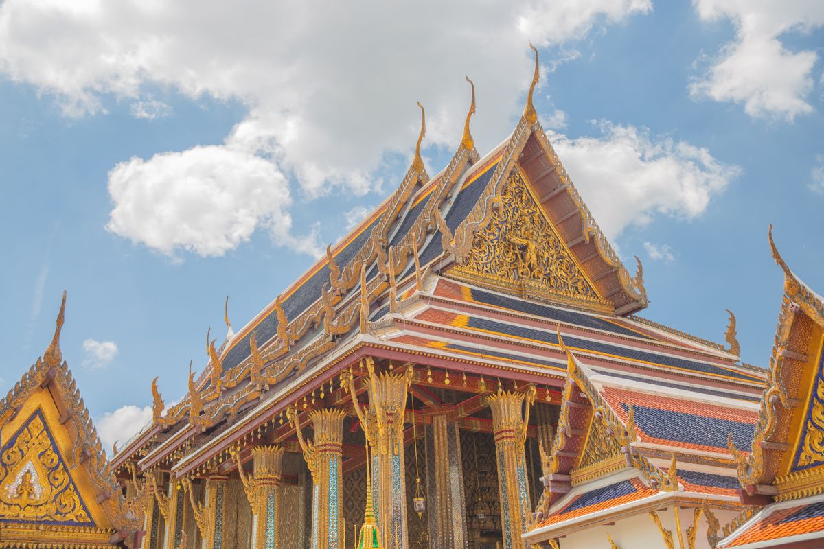 Temple of the Emerald Buddha with golden stupas at the Grand Palace in Bangkok, Thailand
