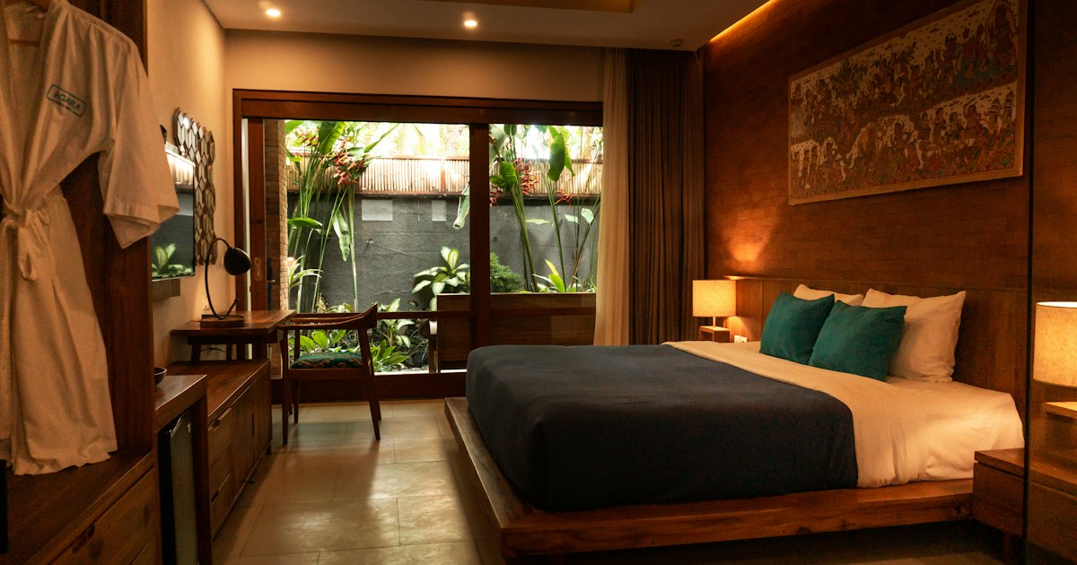 Modern hotel guest room with warm ambient lighting and bedside controls