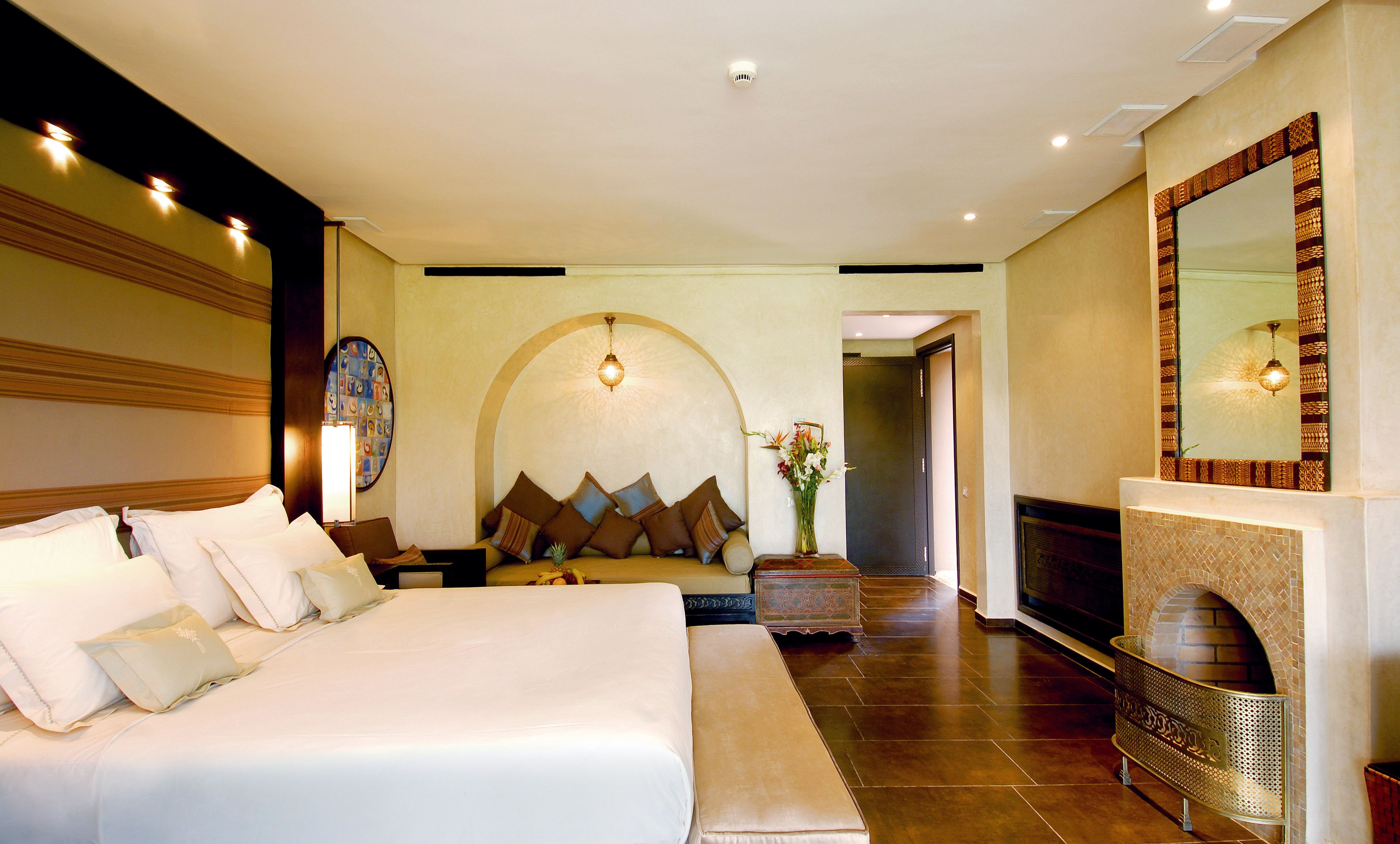 Modern luxury hotel bedroom with warm ambient lighting and elegant furnishings