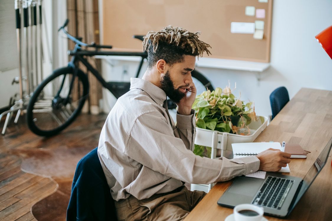 Creator focused on a laptop in a modern workspace