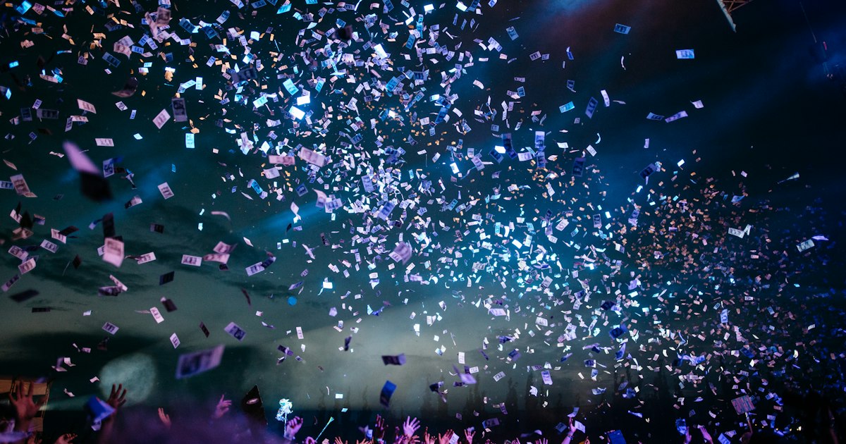 Colorful concert stage lights beaming through atmospheric haze at a live entertainment event