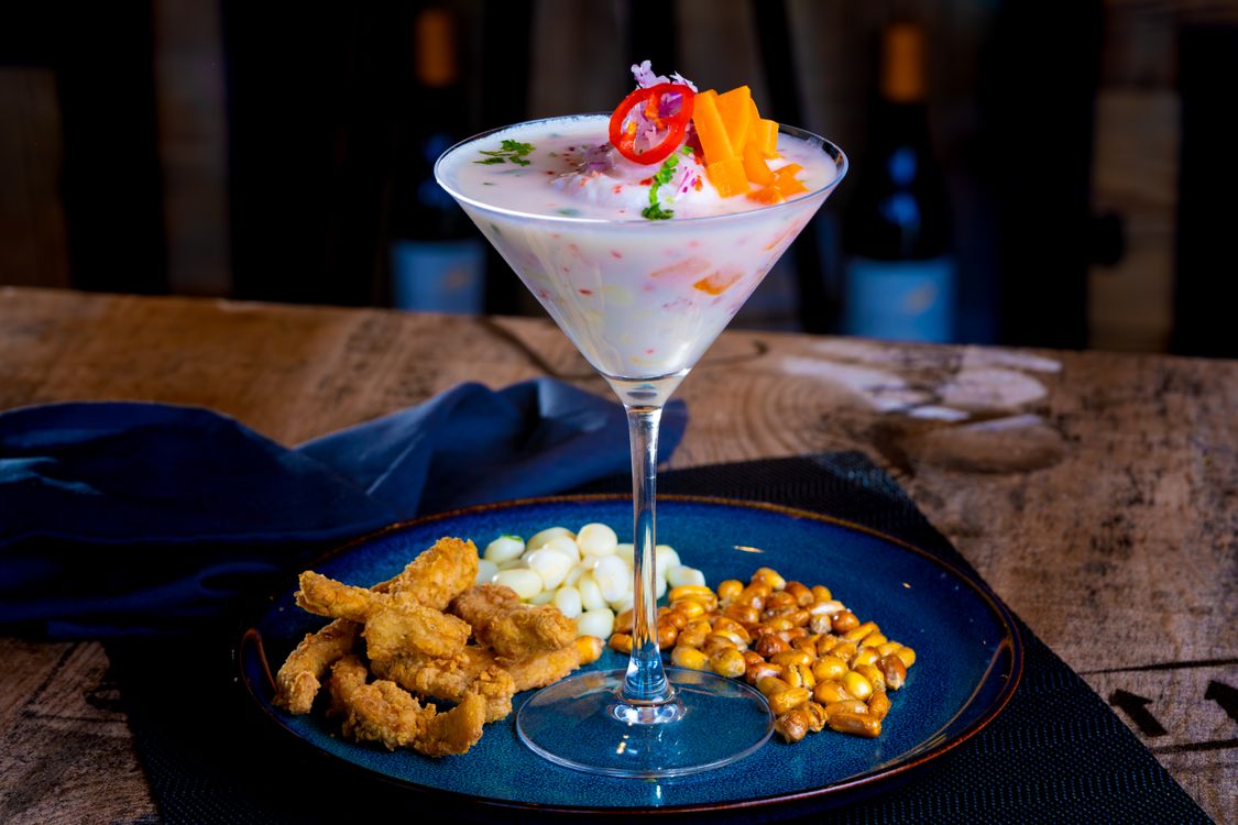 Peruvian ceviche with corn and fried seafood garnish