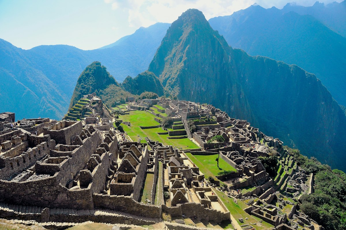 Panoramic view of Peru's Sacred Valley with green agricultural terraces and Andean mountains