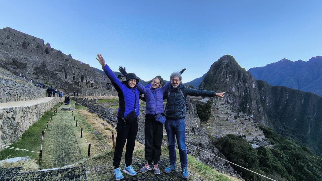 Machu Picchu stone terraces and structures beneath misty Andes peaks
