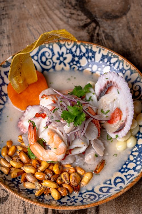 Colorful Peruvian seafood ceviche on a patterned plate