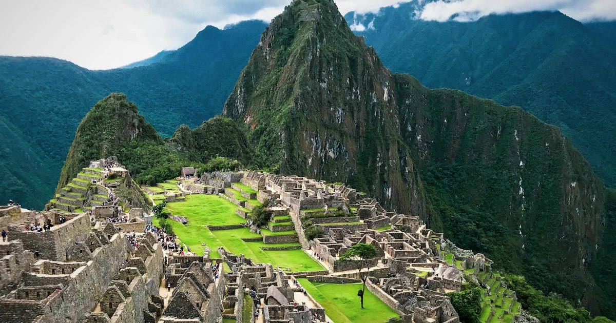 Ancient Inca ruins of Machu Picchu terraces set against misty Andes mountain landscape in Peru