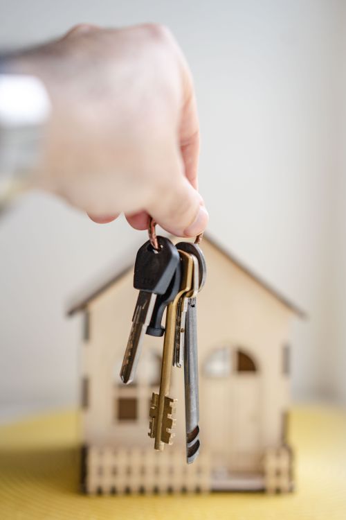 Person holding house keys symbolising home ownership in Ghana